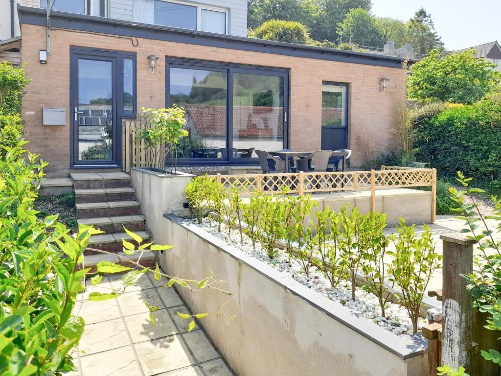 a home with a garden and a patio at High Tide in Combe Martin
