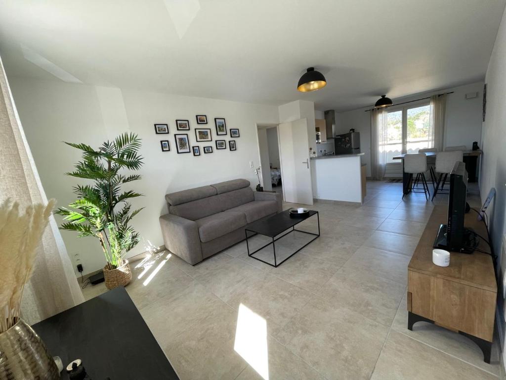 a living room with a couch and a table at Le Lourmarinois in Lourmarin