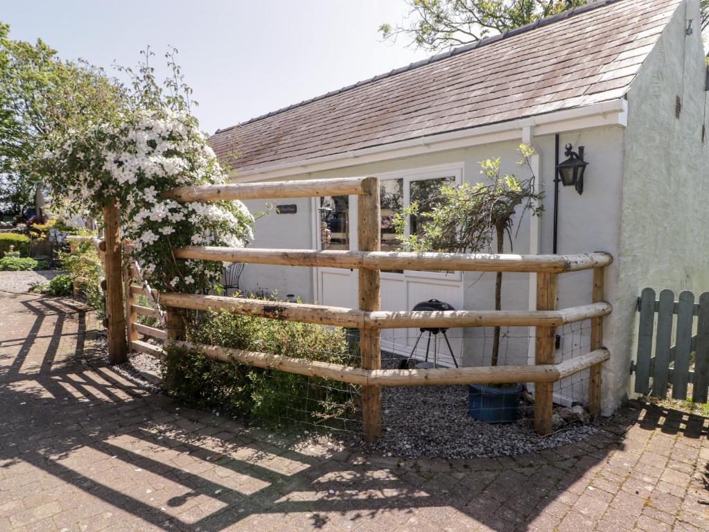 a wooden fence in front of a house at The Duck House in Treffgarne