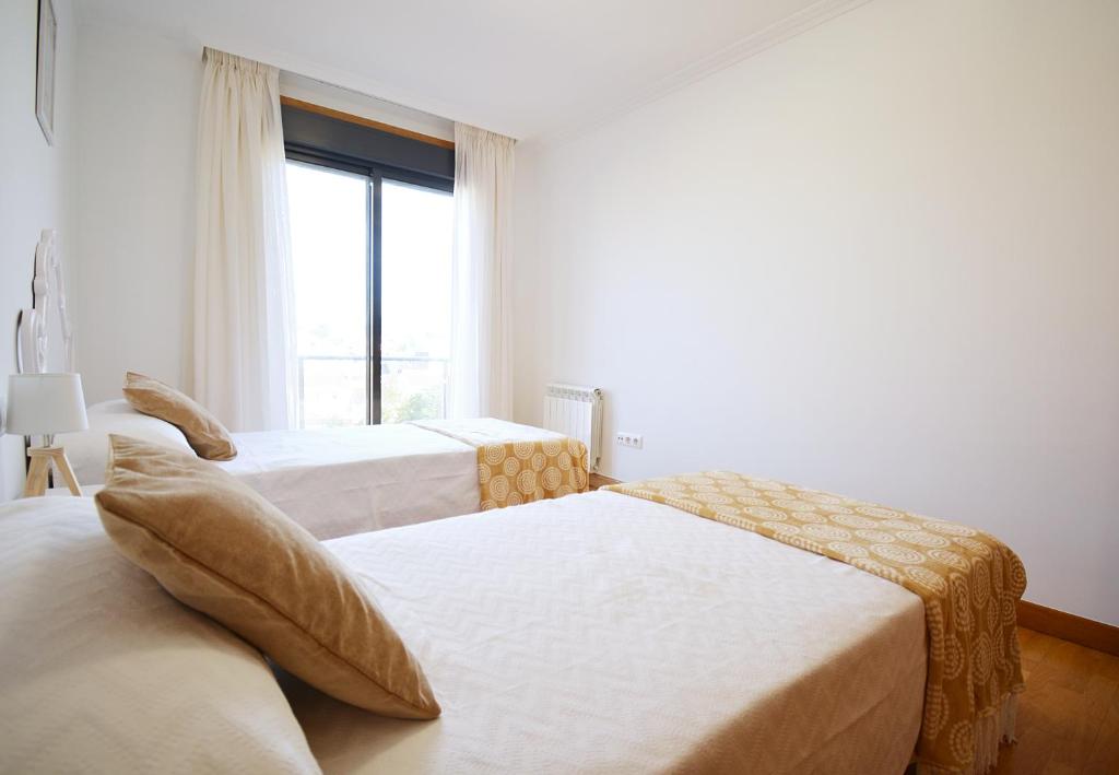 Posteľ alebo postele v izbe v ubytovaní GALIHOST - Céntrico apartamento con parking en Cambados