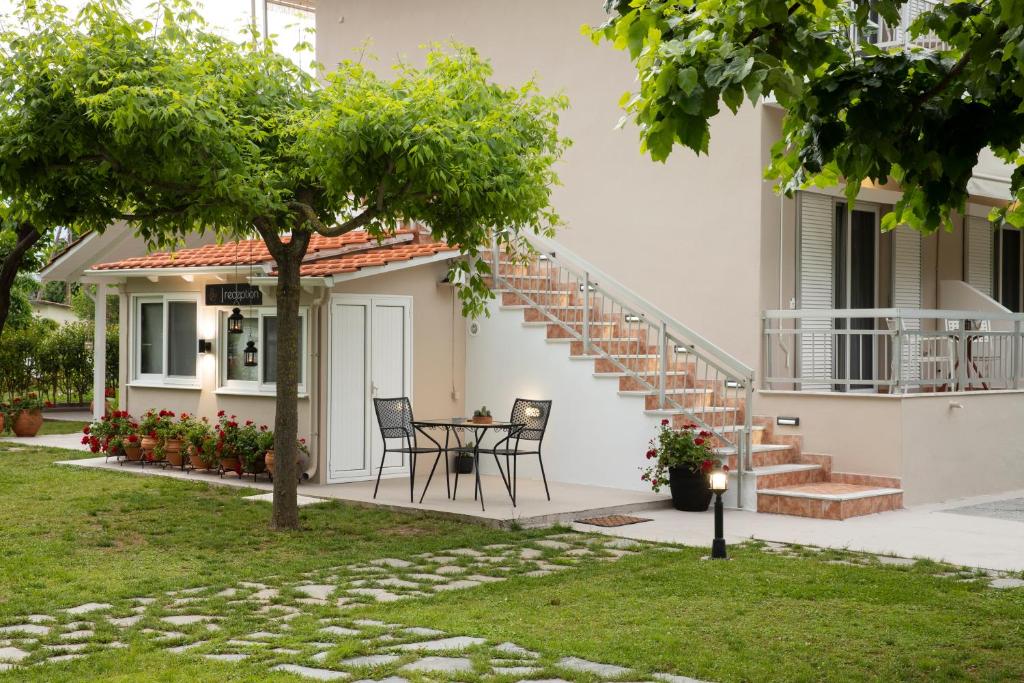 a house with a table and chairs in the yard at Evaggelia rental apartments in Skotína