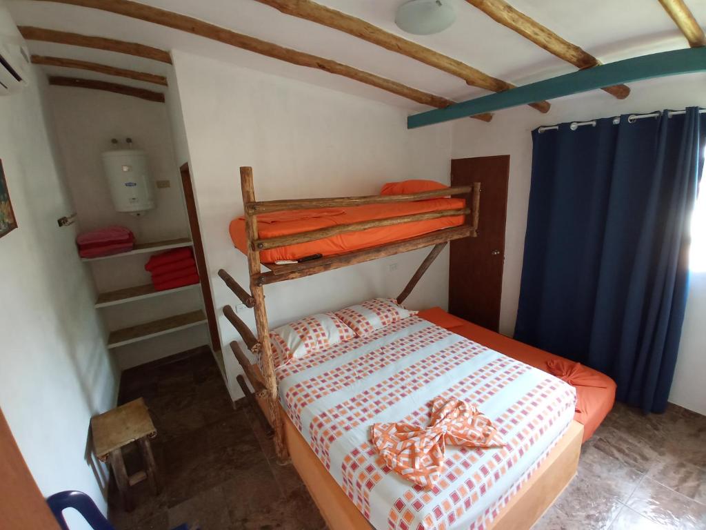 a bedroom with a bunk bed in a room at Casaione in Puerto Colombia