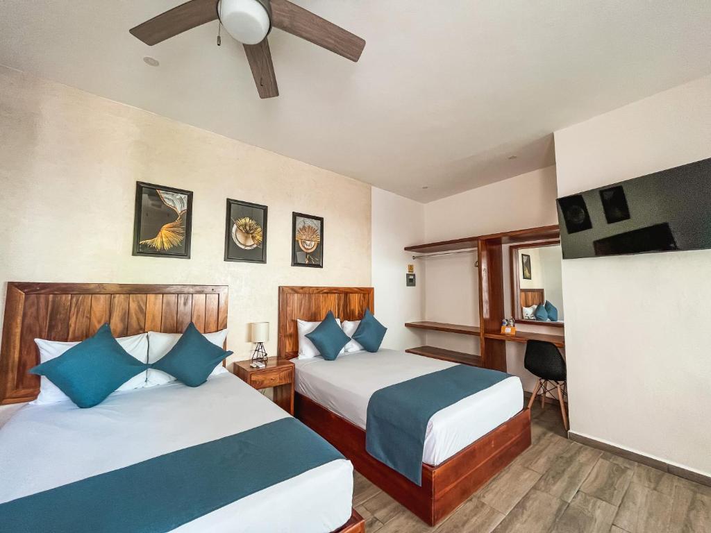 Postel nebo postele na pokoji v ubytování HOTEL KOOKAY VALLADOLID