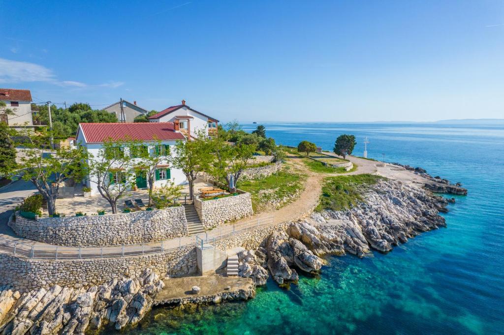 an aerial view of a house on a rocky island in the water at House for rent "Figurica" Lun in Lun