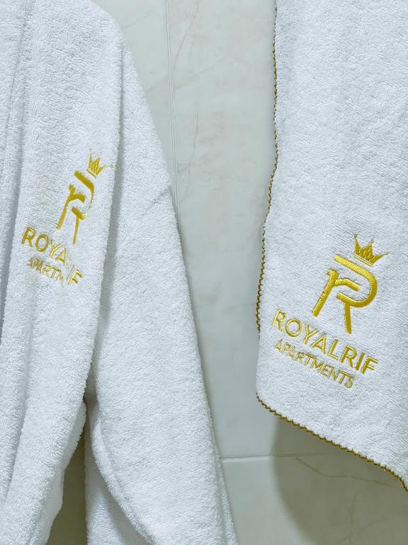 two towels hanging on a wall in a bathroom at Rif Appartment in Al Hoceïma
