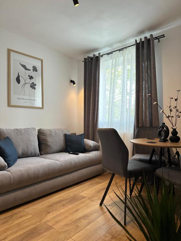 a living room with a couch and a table at Modern Cozy Apartment Zalau in Zalău