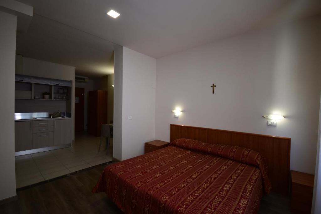 Postel nebo postele na pokoji v ubytování Hotel e Appartamenti La Solaria