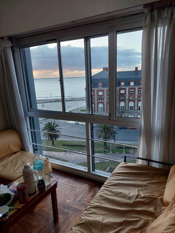 a bedroom with a large window with a view of the ocean at Depto con vista al mar in Mar del Plata