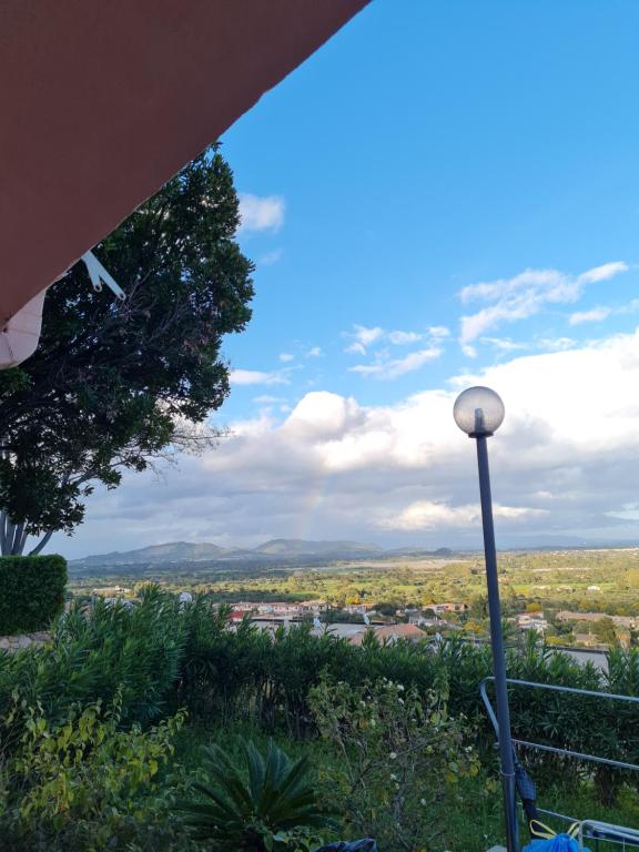 a view of a city from a hill with a street light at Villa Bellavista IS MOLAS PULA, CAGLIARI in Santa Margherita di Pula