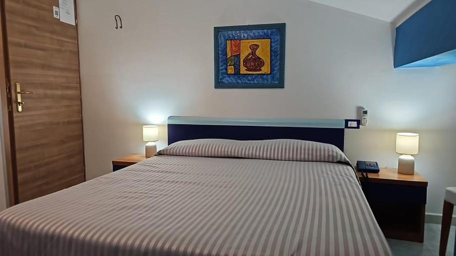 Postel nebo postele na pokoji v ubytování Hotel Il Gioiello