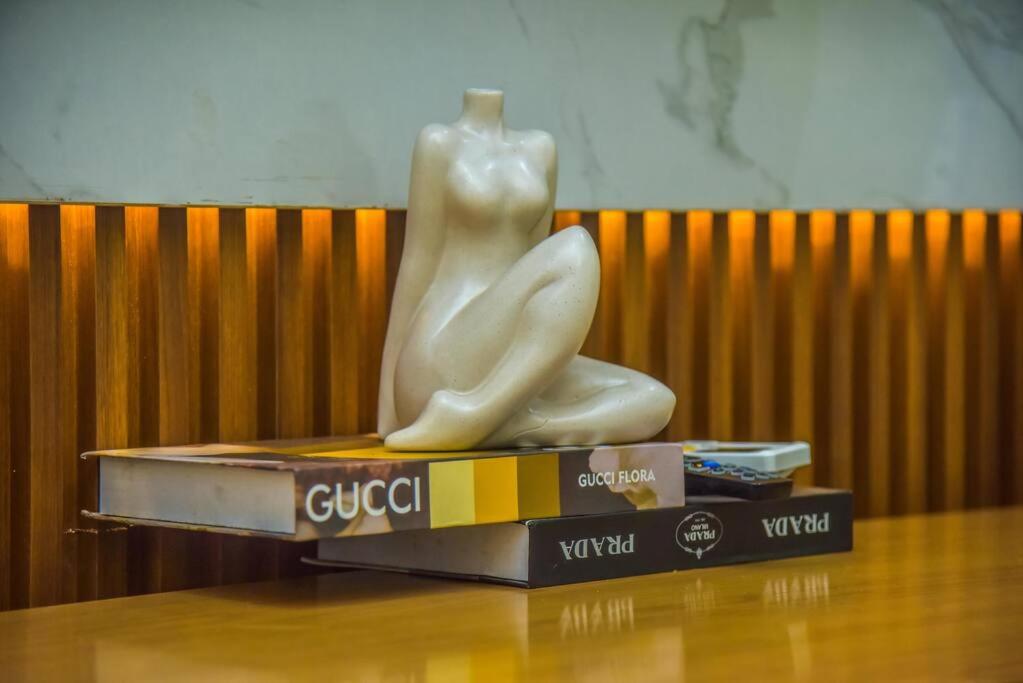 a statue of a woman sitting on a book at Luxurious1 bedroom apart in VI in Lagos