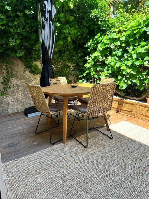 a wooden table and chairs on a patio at Appartement Centre ville Menton in Menton