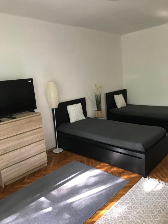 a living room with a couch and a flat screen tv at Központi apartman in Kiskunfélegyháza