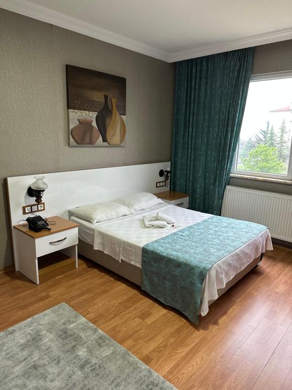 a hotel room with a bed and a window at GÖKTÜRK APART in Trabzon