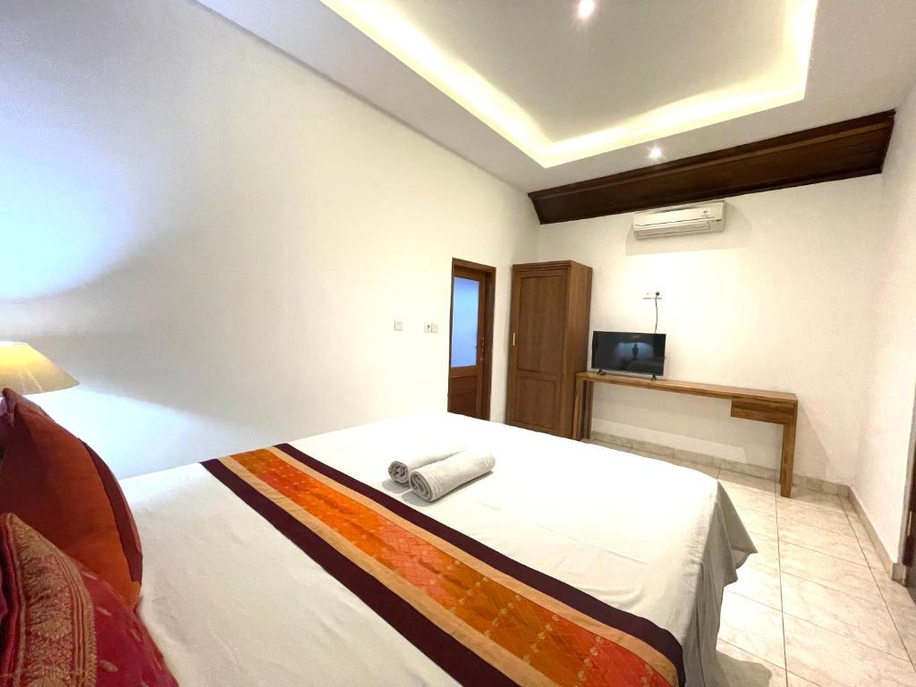 Postel nebo postele na pokoji v ubytování DIMUWA Ubud