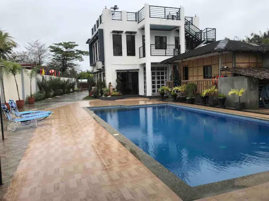 a house with a swimming pool in front of a house at Rainiers Private Resort House with 2 rooms 