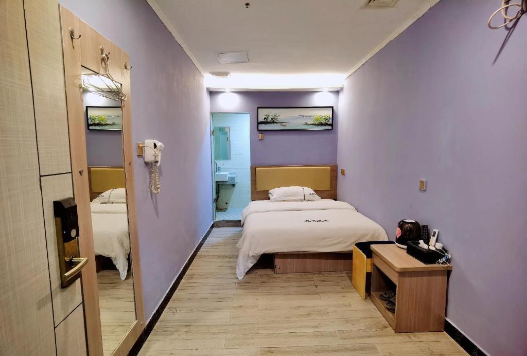 Postel nebo postele na pokoji v ubytování Songyuan Hotel 松缘酒店