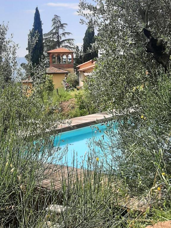 a swimming pool in front of a house at Villa Al Ponte in Case Malva