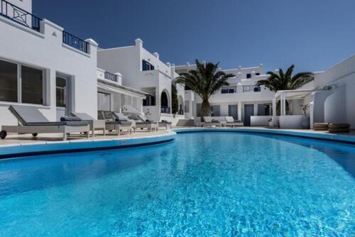 a large swimming pool in front of a house at Lofos Village in Ios Chora