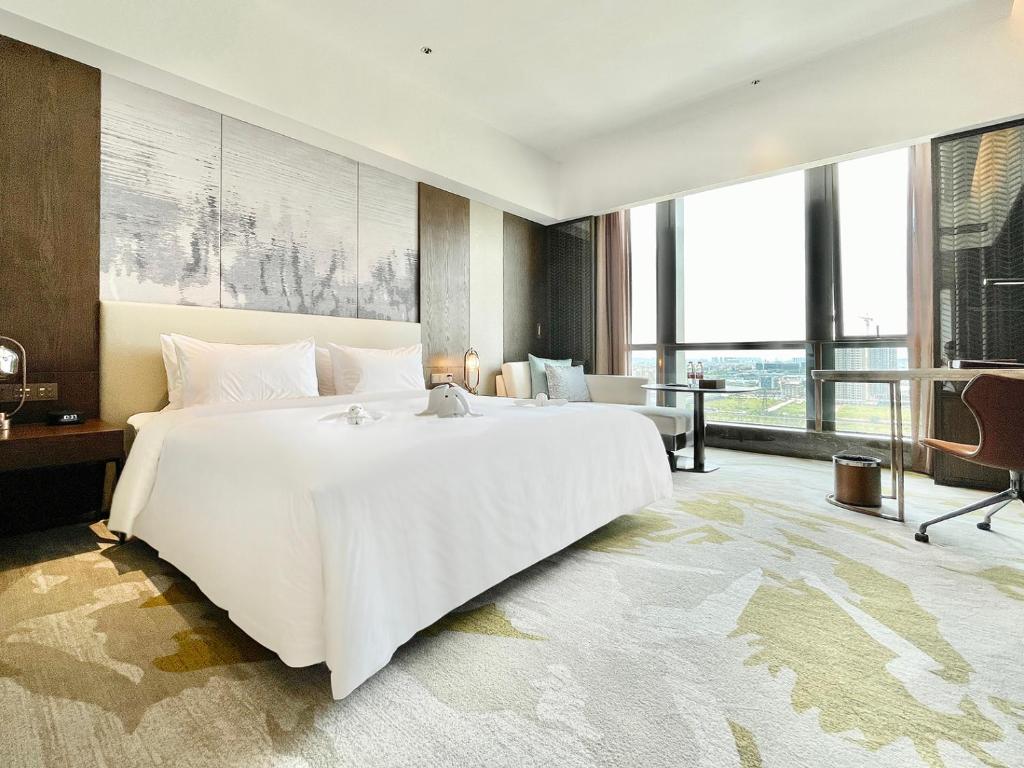 Postel nebo postele na pokoji v ubytování White Swan VYV Hotel, Foshan