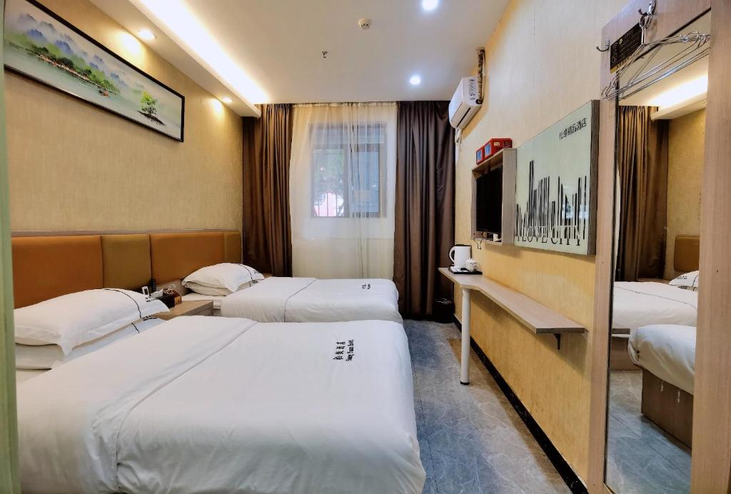 Postel nebo postele na pokoji v ubytování Songyuan Hotel 松缘酒店