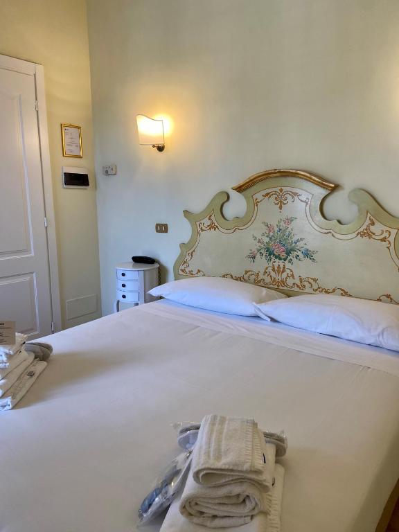 Postel nebo postele na pokoji v ubytování Sourire Hotel
