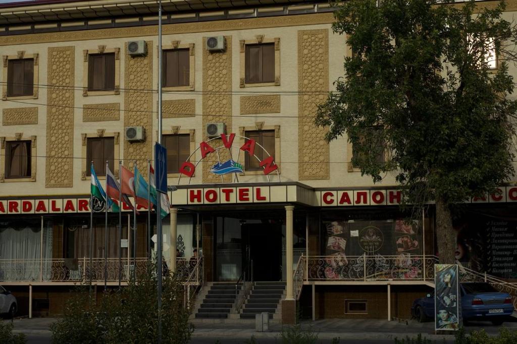 ein Hotel mit vielen Flaggen davor in der Unterkunft Davan LUX in Taschkent