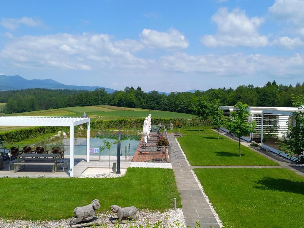 a view of a garden with a fountain and a building at Glamping Malerič in Dragatuš