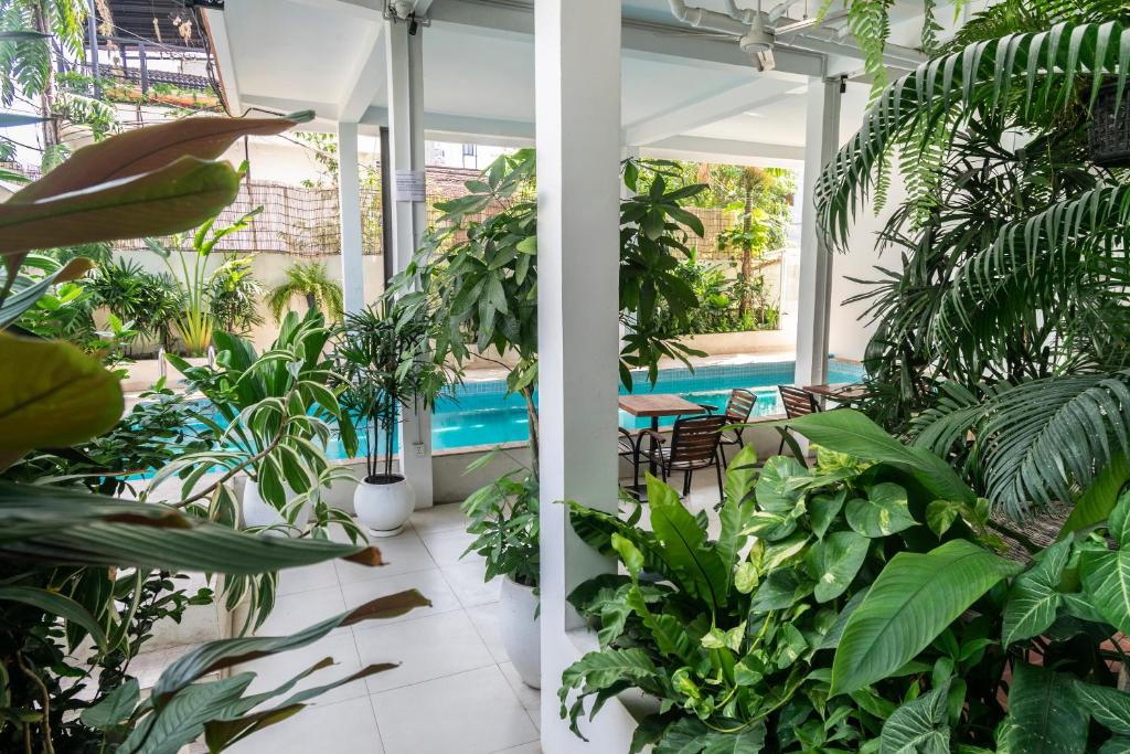 a room filled with lots of plants and a swimming pool at Onederz Siem Reap in Siem Reap