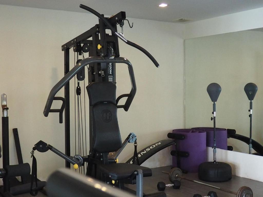 a room with a gym with a treadmill at Anyavee Tubkaek Beach Resort in Tab Kaek Beach