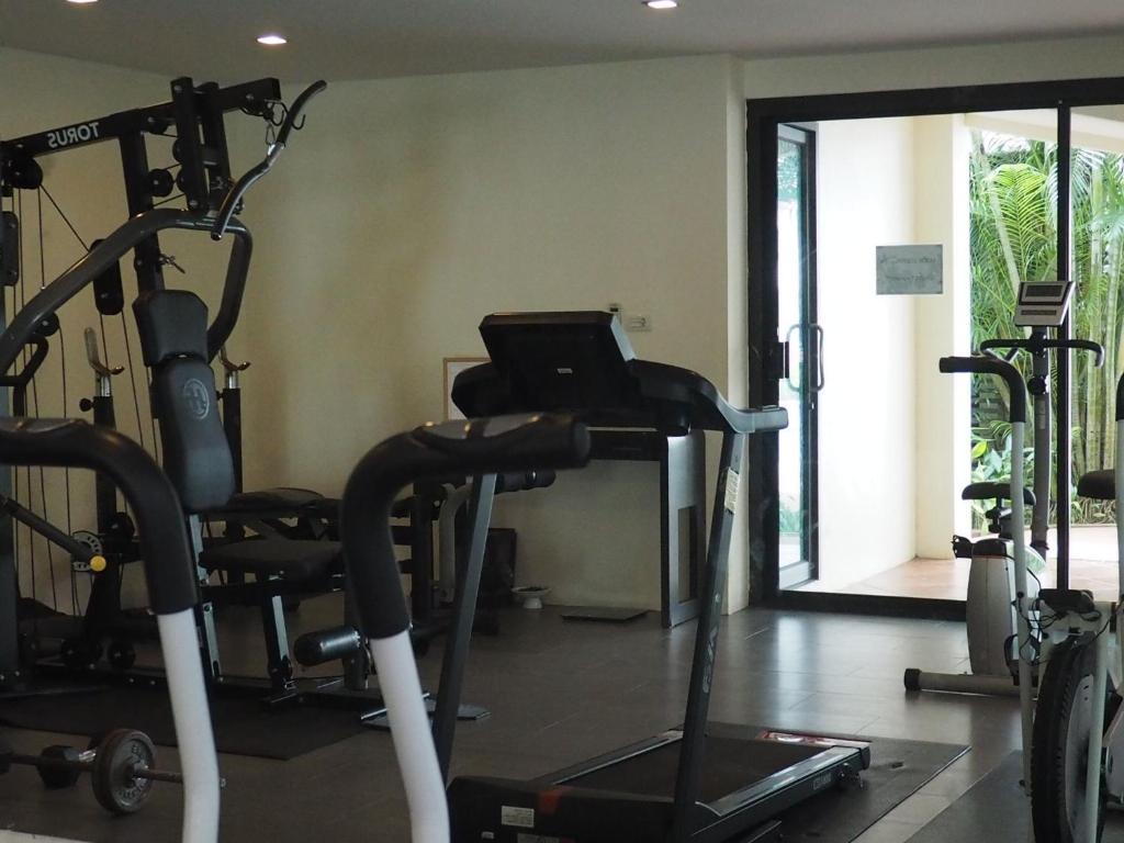 a gym with several tread machines and a treadmill at Anyavee Tubkaek Beach Resort in Tab Kaek Beach