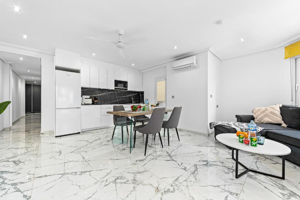 a living room with a couch and a table at Apolo beach front - sea view luxury apartment in Torrevieja