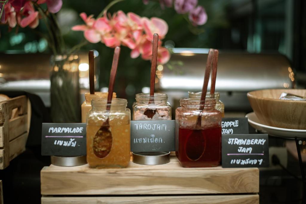 a group of jars of food on a table at Anyavee Tubkaek Beach Resort in Tab Kaek Beach