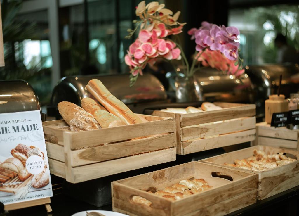 a display of breads and pastries in wooden crates at Anyavee Tubkaek Beach Resort in Tab Kaek Beach