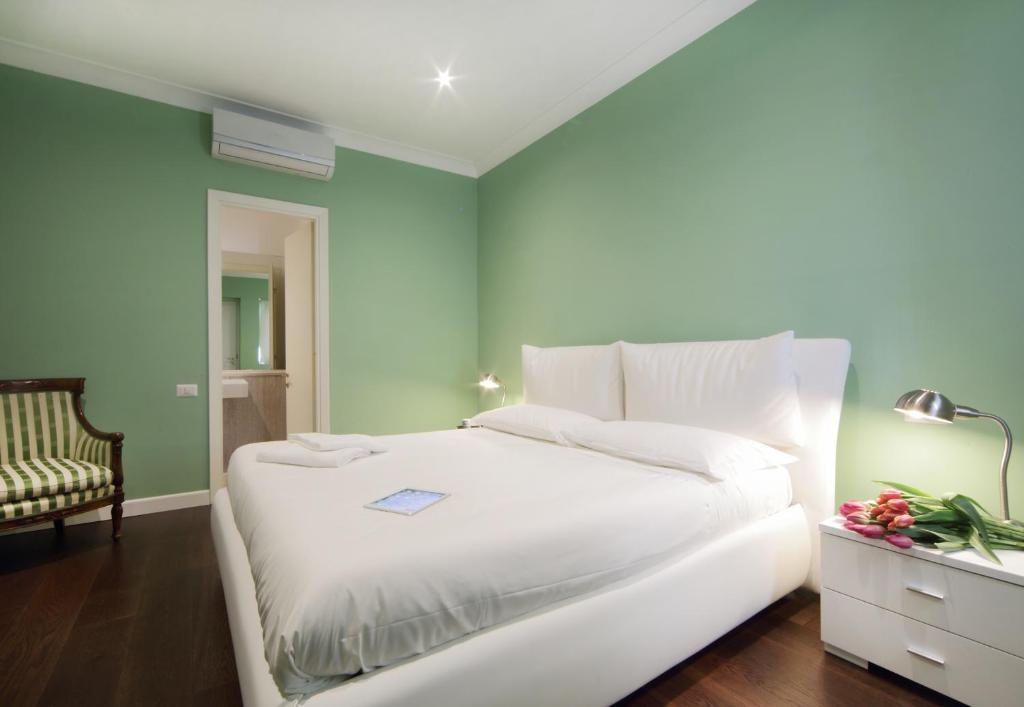 A bed or beds in a room at The One Prati Rooms