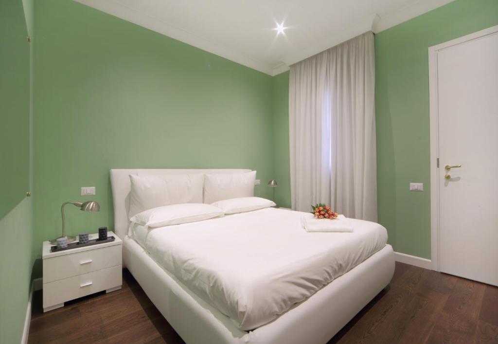 A bed or beds in a room at The One Prati Rooms
