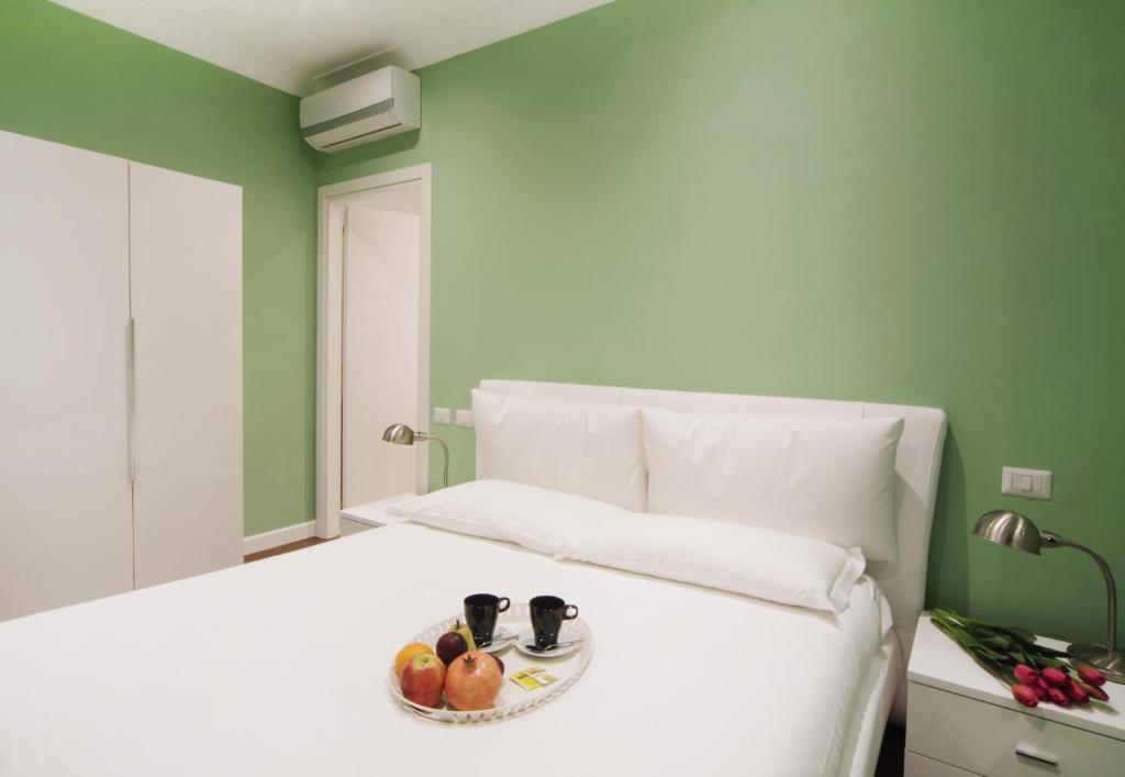 A bed or beds in a room at The One Prati Rooms