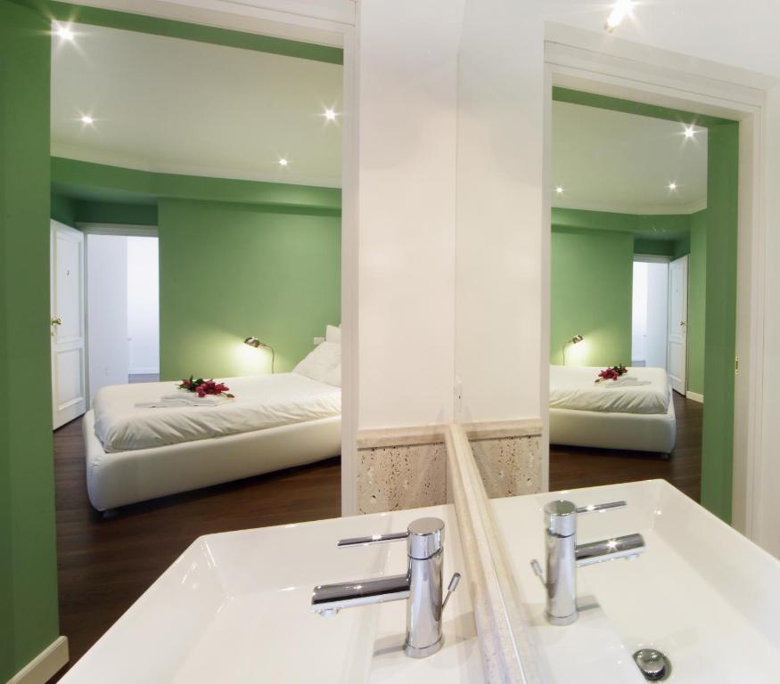 A bed or beds in a room at The One Prati Rooms