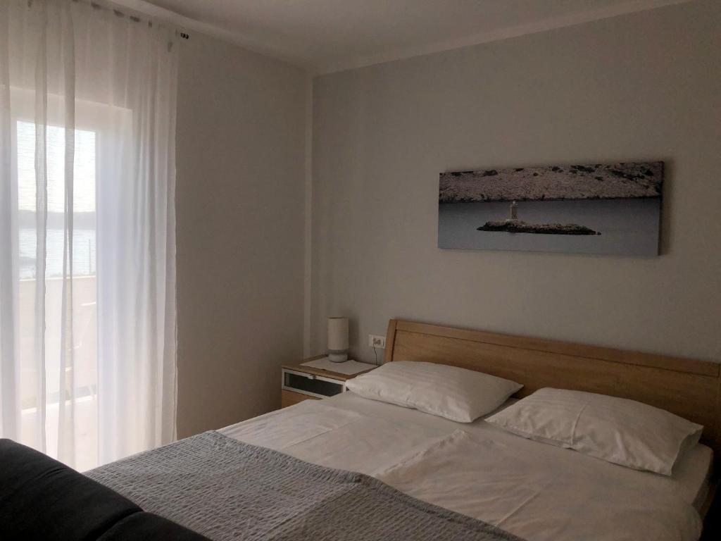 Postel nebo postele na pokoji v ubytování Apartments Aco
