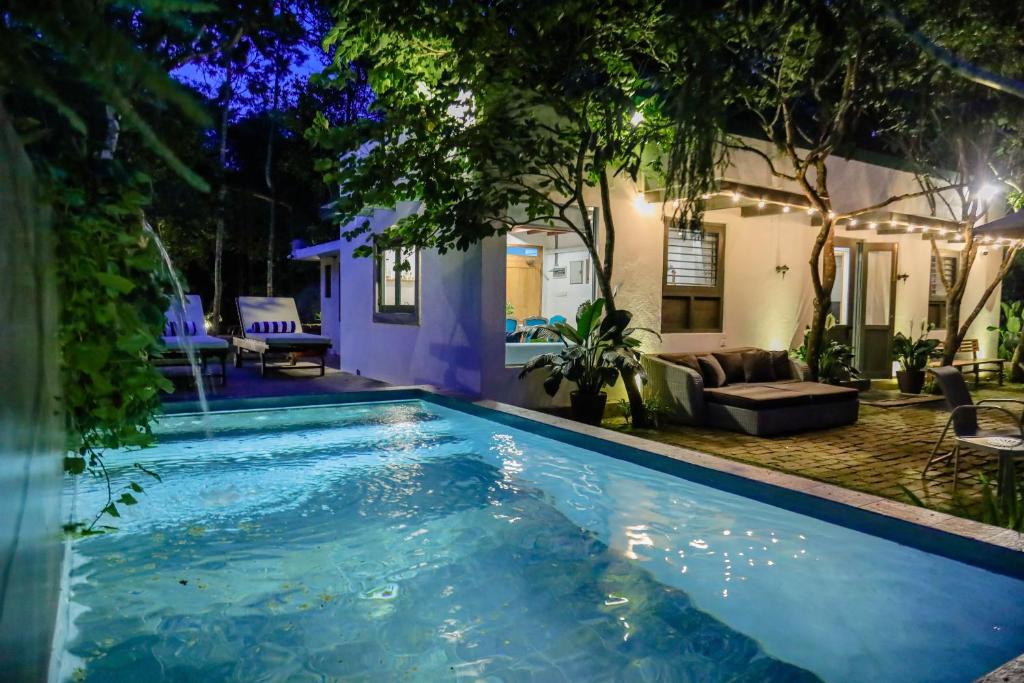 una piscina frente a una casa por la noche en Tranquilisle en Kandy