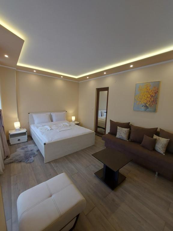 a large bedroom with a bed and a couch at Elegant Complex in Pazardzhik