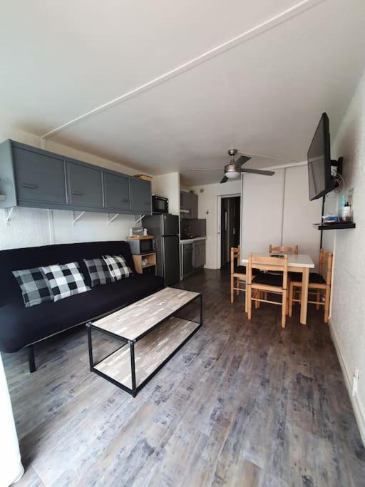 un salon avec un canapé et une table dans l'établissement Le lagon bleu, au Grau-du-Roi