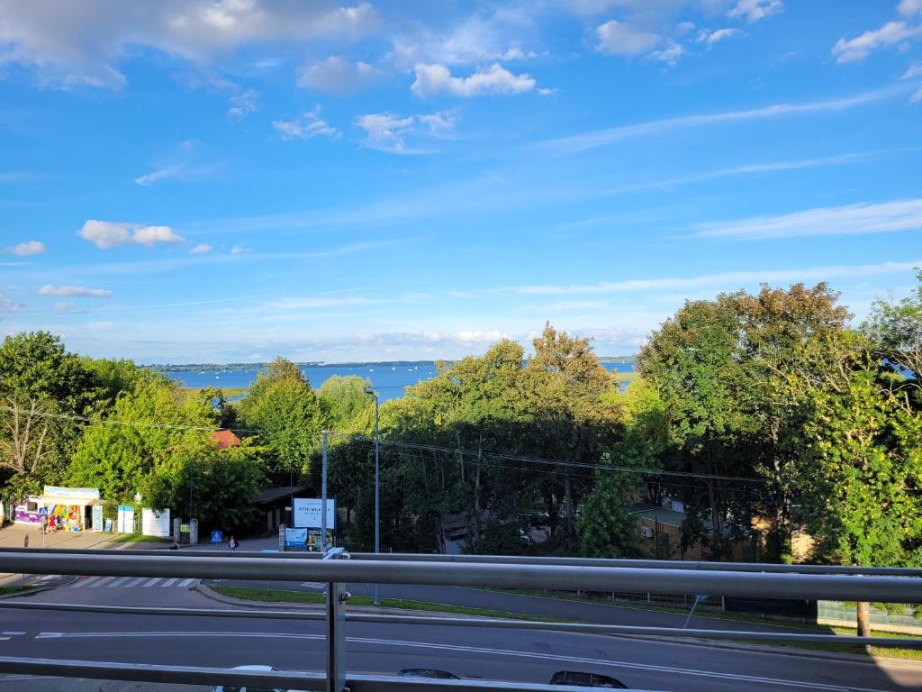 a view of a road with trees and the ocean at Apartament Niegocin Garaż Basen Plaża Giżycko Wilkasy in Wilkasy