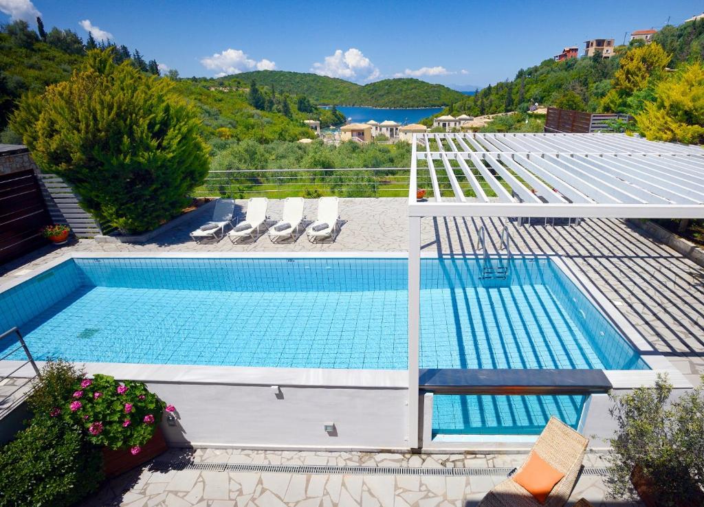 a swimming pool with a view of a mountain at Sivota Senses - Villa Loukas in Sivota