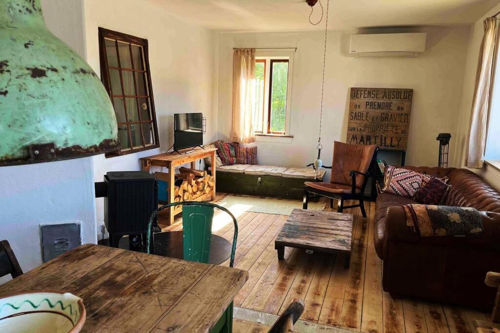 a living room with a couch and a table at The Old Soap House - stylish and close to beach in Vang