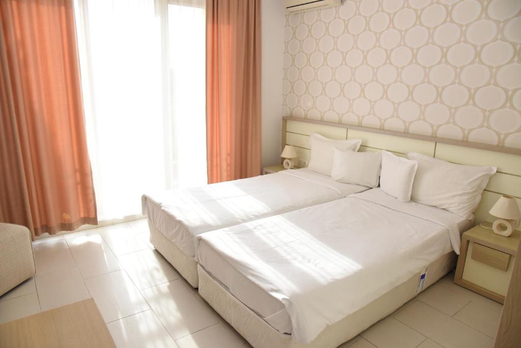 Postel nebo postele na pokoji v ubytování Hotel Paradise Garden
