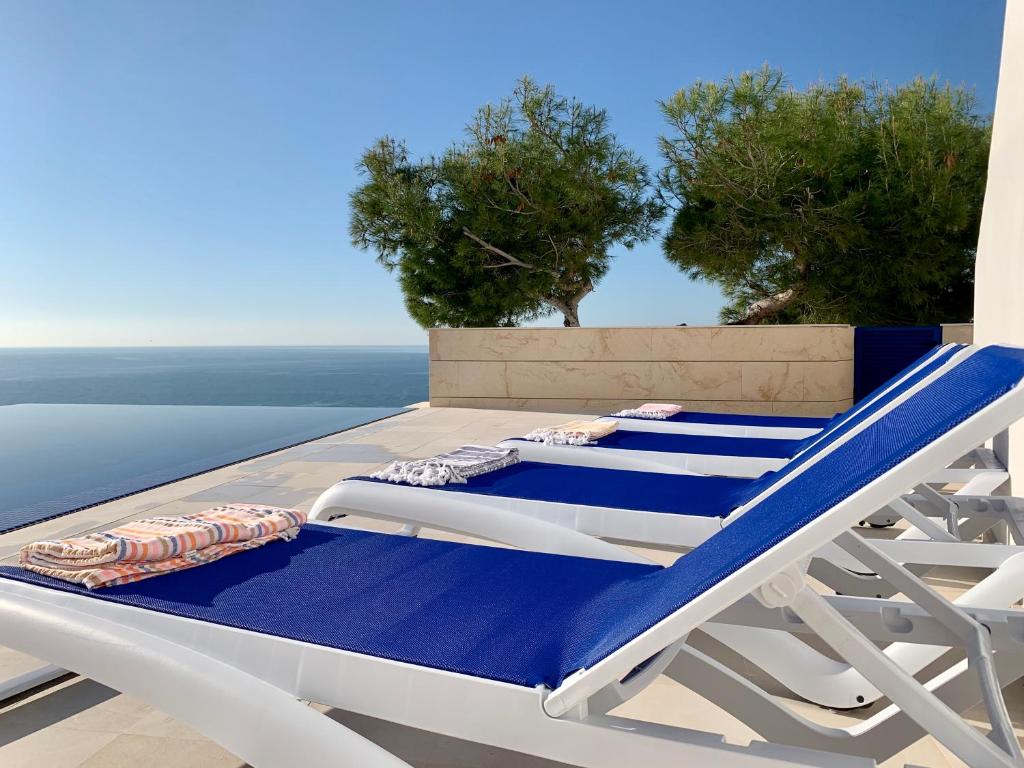 two lounge chairs and a bed on a deck at La Vie est Belle in Jávea