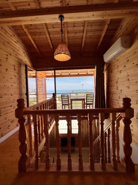 a dining room with a table and a large window at Nashos Bungalows in Spile