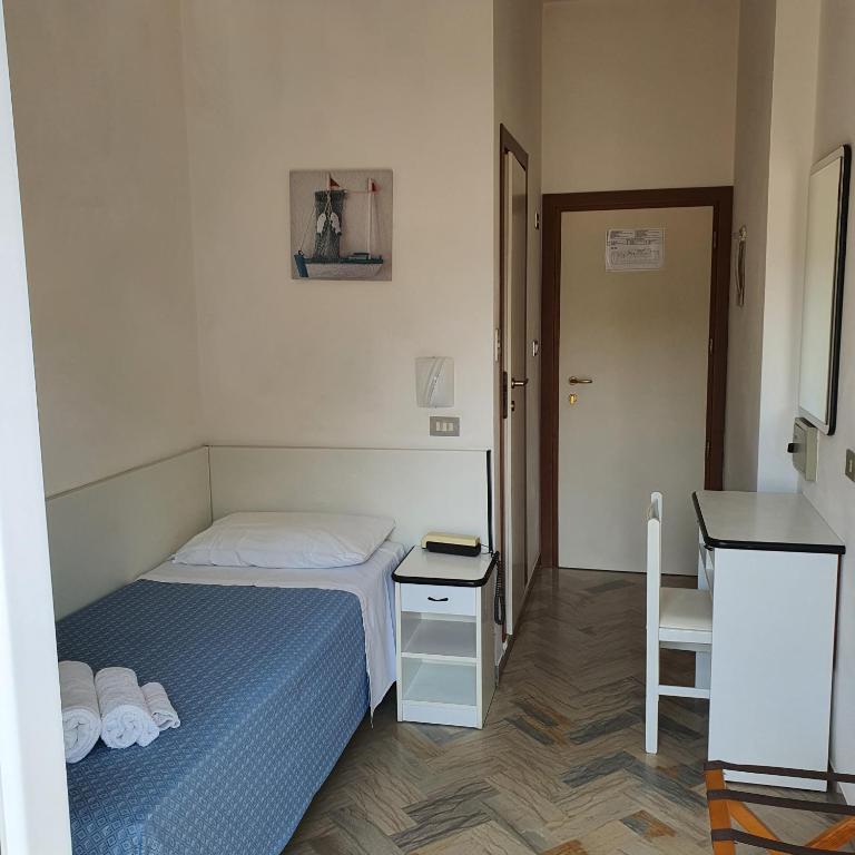 Postel nebo postele na pokoji v ubytování Hotel Tre Assi