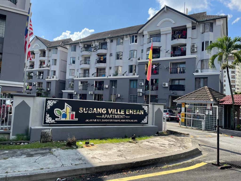 a building with a sign in front of it at Subang Ville Ehsan Apartment in Kampong Baharu Sungai Way